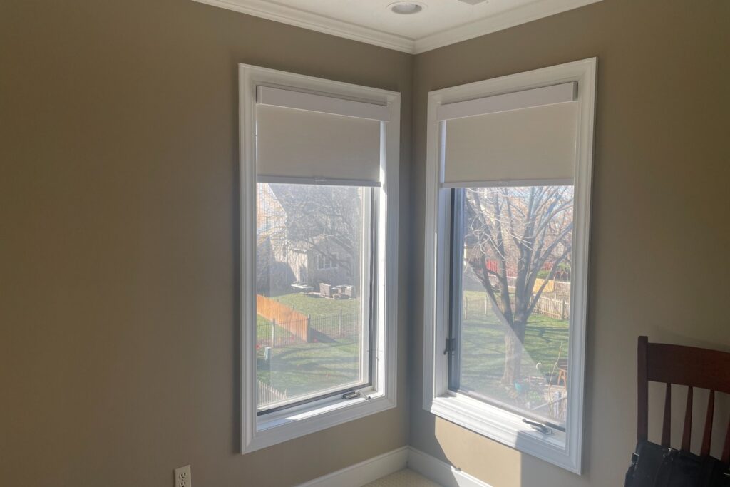 Light filtering roller shades on corner windows in a Kansas City home